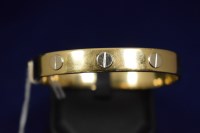 Lot 56 - A yellow metal bangle, in the manner of...