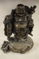 Lot 379 - A bronze Buddah with a branch over his...