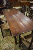 Lot 673 - A large rectangular rustic oak dinning table...