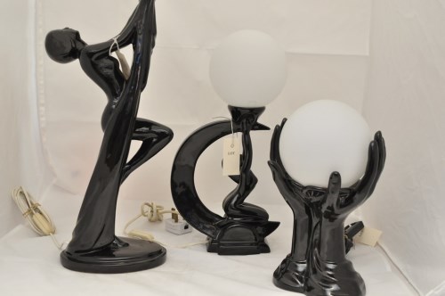 Lot 1107 - Two Art Deco style black pottery table lamps...