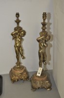 Lot 185 - A pair of brass table lamps in the form of putti.
