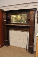 Lot 622 - An Arts and Crafts carved and stained oak fire...