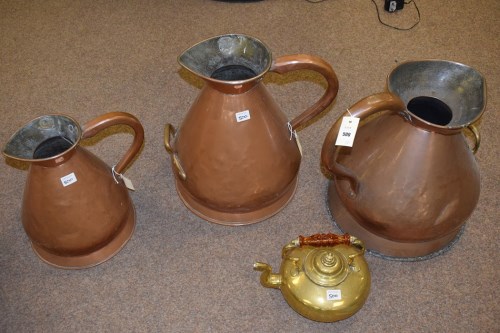 Lot 500 - Three large 19th Century copper measure jugs;...
