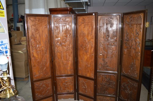 Lot 551 - A modern carved Oriental hardwood four-fold...