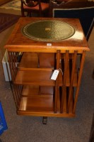 Lot 599 - A reproduction yew wood revolving bookcase...