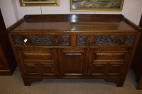 Lot 671 - An early 20th Century carved and stained oak...