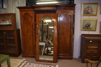 Lot 672 - A Victorian mahogany break front three door...