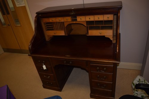 Lot 710 - An early 20th Century mahogany roll top desk...