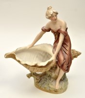 Lot 135 - Royal Dux figure of a lady seated upon a large...