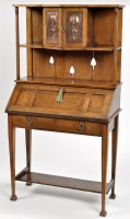 Lot 331 - An early 20th Century Arts & Crafts oak bureau,...