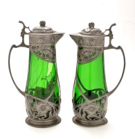 Lot 350 - A pair of WMF style claret jugs, the green...