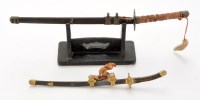 Lot 388 - Two 20th Century miniature Japanese katana...