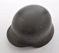 Lot 440 - A German WWII M35 helmet, the green painted...