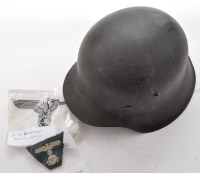 Lot 441 - A German WWII M42 helmet, the green painted...