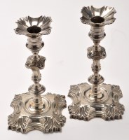 Lot 512 - A pair of George II silver candlesticks, by...