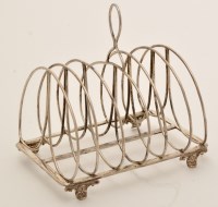 Lot 585 - A George III silver seven bar toast rack, by...