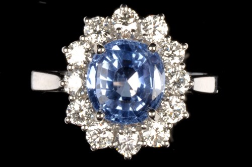 Lot 642 - A sapphire and diamond cluster ring, the oval...