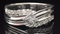 Lot 644 - A diamond ring, the central princess cut...