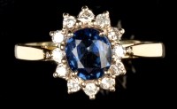 Lot 645 - A sapphire and diamond cluster ring, the oval...