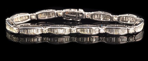 Lot 653 - A diamond bracelet, of eleven graduated links...