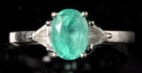 Lot 656 - An emerald and diamond ring, the oval facet...