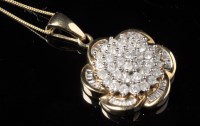 Lot 657 - A diamond pendant, the four-tier central...