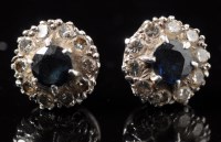 Lot 661 - A pair of sapphire and diamond cluster...