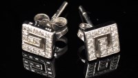 Lot 662 - A pair of diamond earrings, of Greek key form...