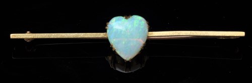 Lot 664 - An opal bar brooch, the heart-shaped opal...