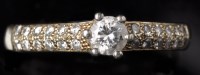 Lot 668 - A diamond ring, the central brilliant cut...