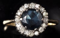 Lot 670 - A sapphire and diamond cluster ring, the...