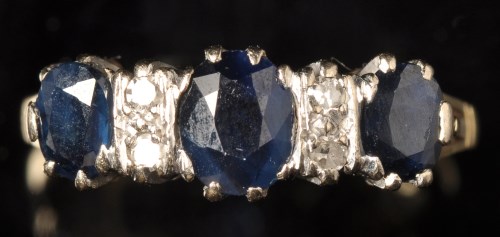 Lot 671 - A sapphire and diamond ring, the three oval...
