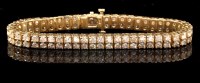 Lot 672 - A diamond double row tennis bracelet, each...