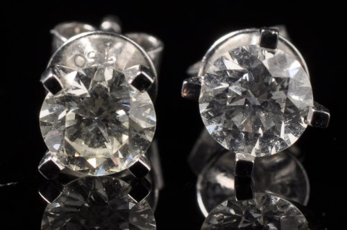 Lot 676 - A pair of diamond stud earrings, each...