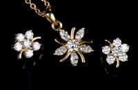 Lot 678 - A diamond pendant and matching earrings, the...