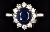 Lot 688 - A sapphire and diamond cluster ring, th...