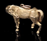 Lot 691 - A 9ct. yellow gold horse pattern pendant,...