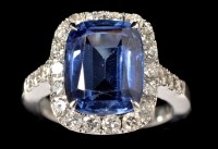 Lot 702 - A sapphire and diamond cluster ring, the...