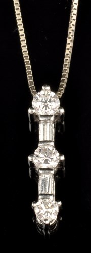 Lot 704 - A diamond pendant, set with three graduated...