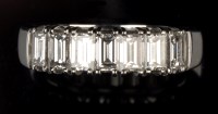 Lot 716 - A seven stone diamond ring, the baguette-cut...