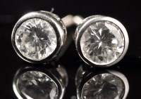 Lot 730 - A pair of diamond stud earrings, each weighing...