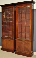 Lot 820 - A pair of mahogany bookcases, each with flared...