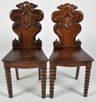 Lot 836 - A pair of Victorian oak hall chairs, with...