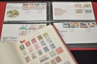 Lot 164 - An album of world stamps together with a file...