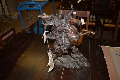 Lot 911 - A bronze figure of a Chinaman on a rearing horse.