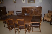 Lot 1150 - 1940's carved oak dining room suite comprising...