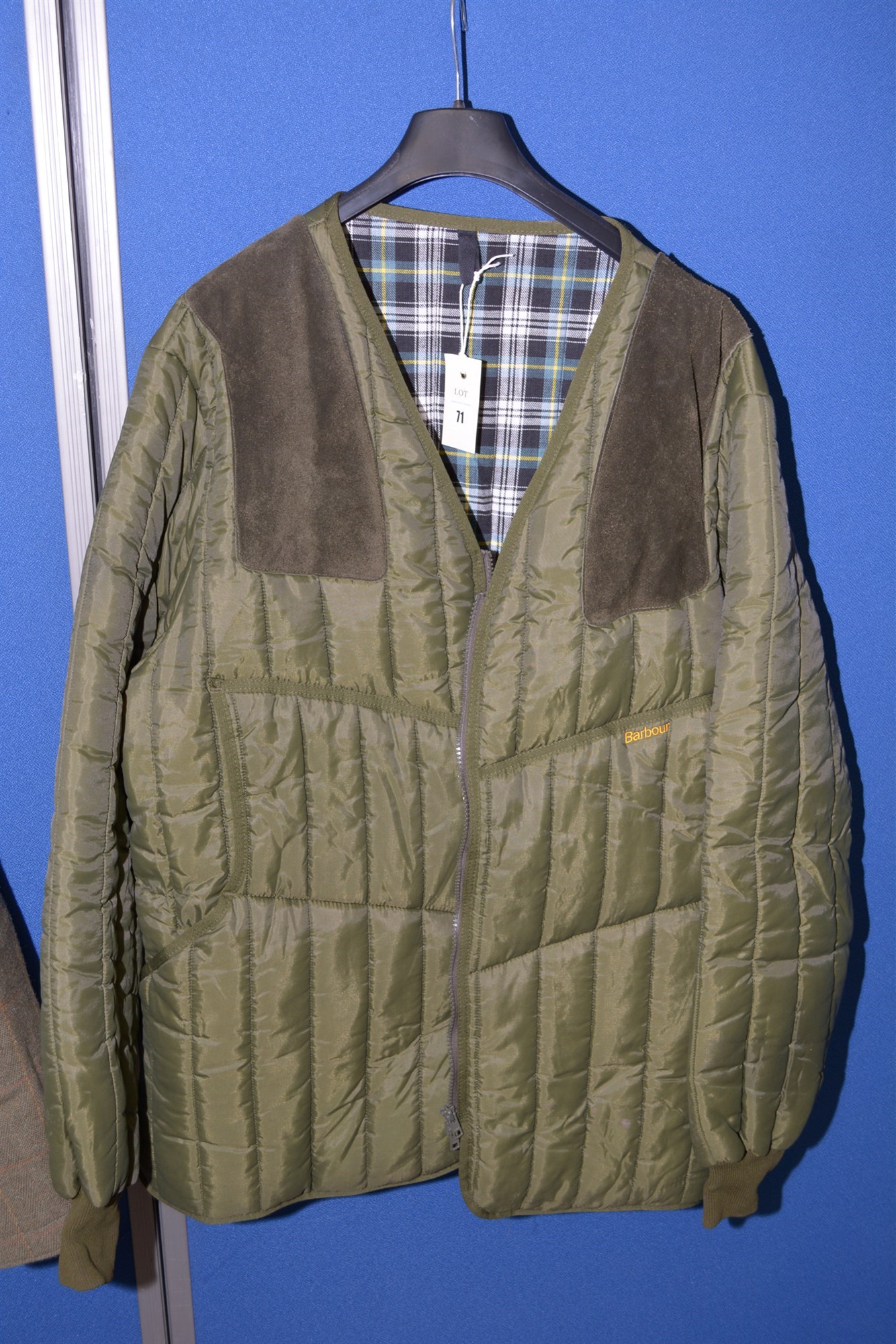 Lot 71 - A Barbour green quilted shooting jacket, with