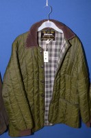 Lot 75 - A Barbour quilted jacket in green, with green...