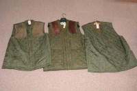 Lot 86 - Three green quilted nylon waistcoats, one...