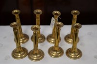 Lot 23 - A set of eight modern brass candlesticks.